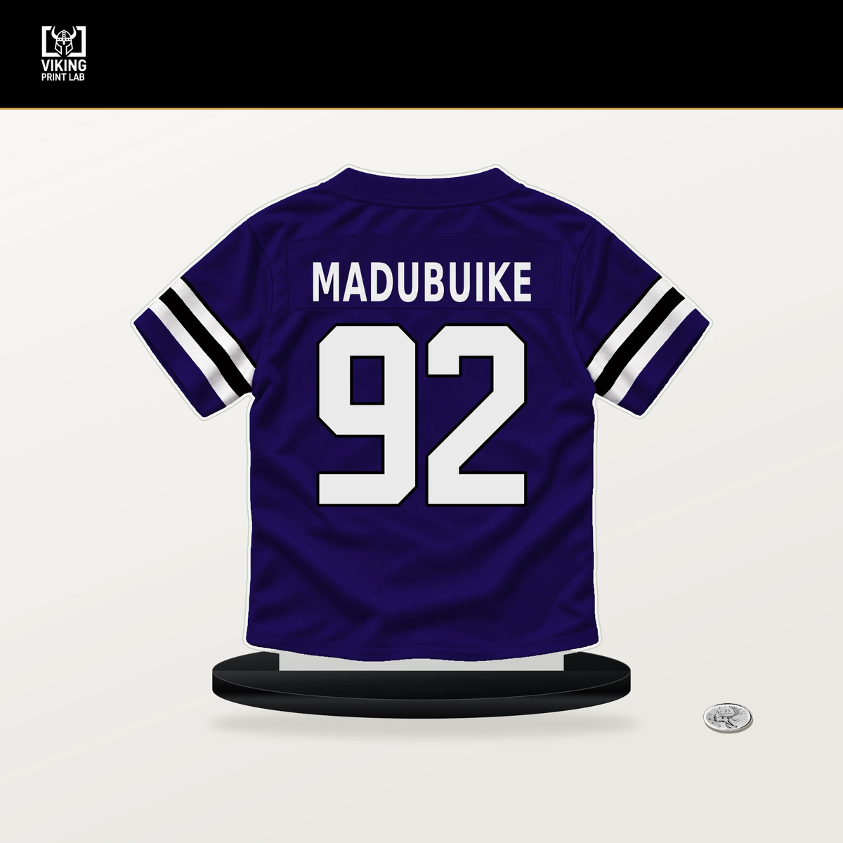 Nnamdi Madubuike number 92 Baltimore Ravens jersey stand with included black base.