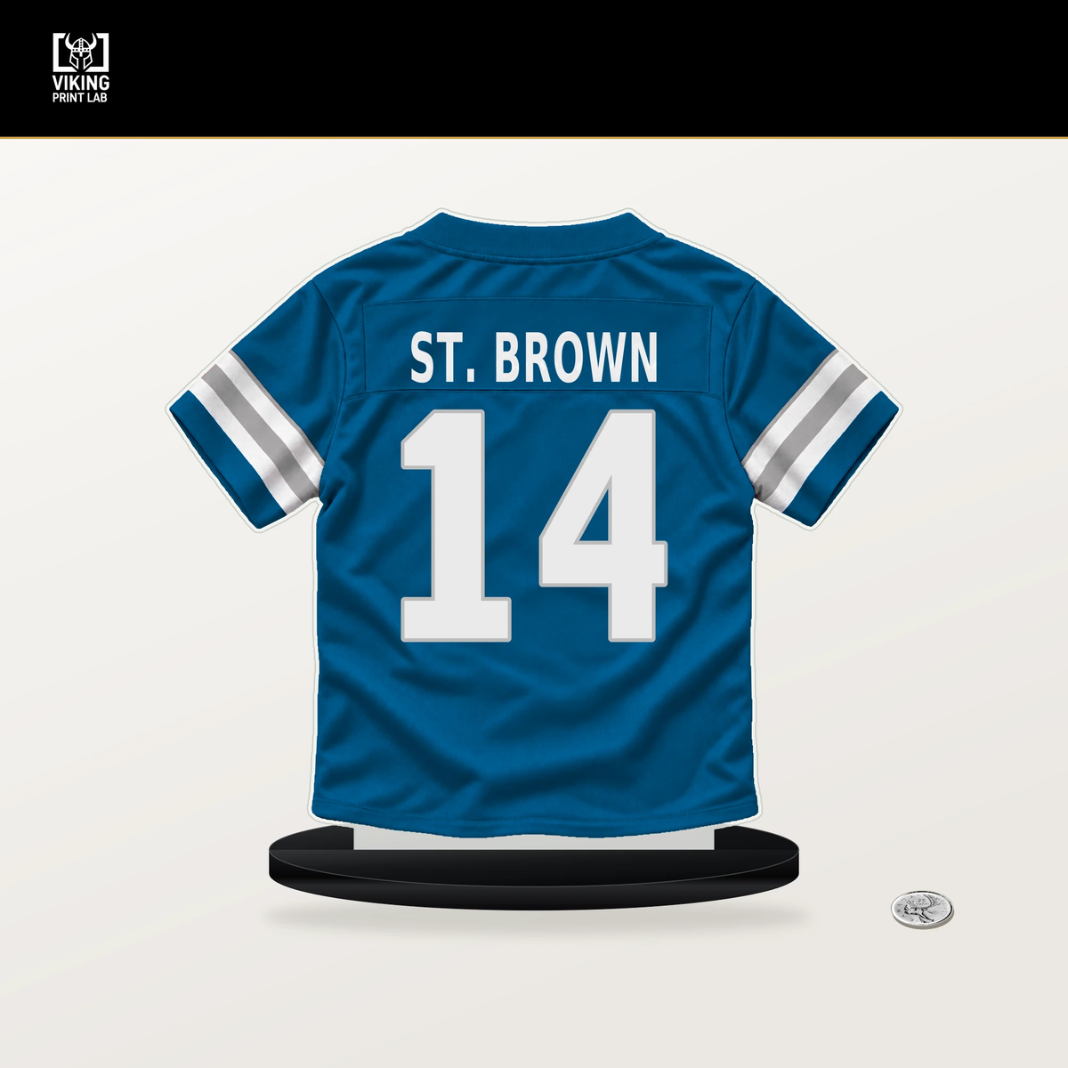 Amon-Ra St. Brown number 14 Detroit Lions jersey stand with included black base.