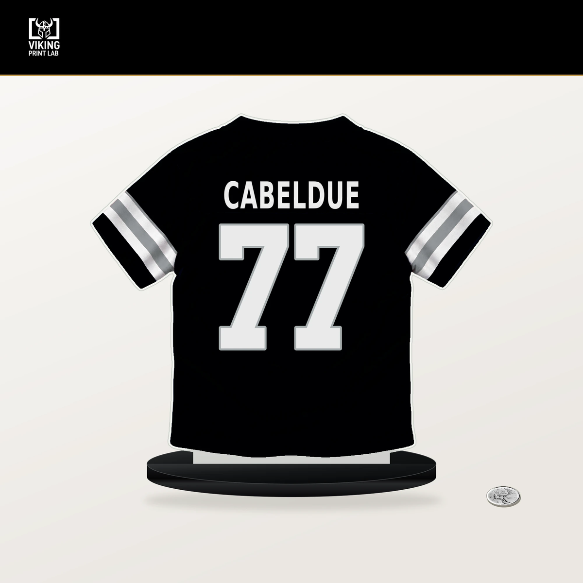 Bryce Cabeldue number 77 Las Vegas Raiders jersey stand with included black base.