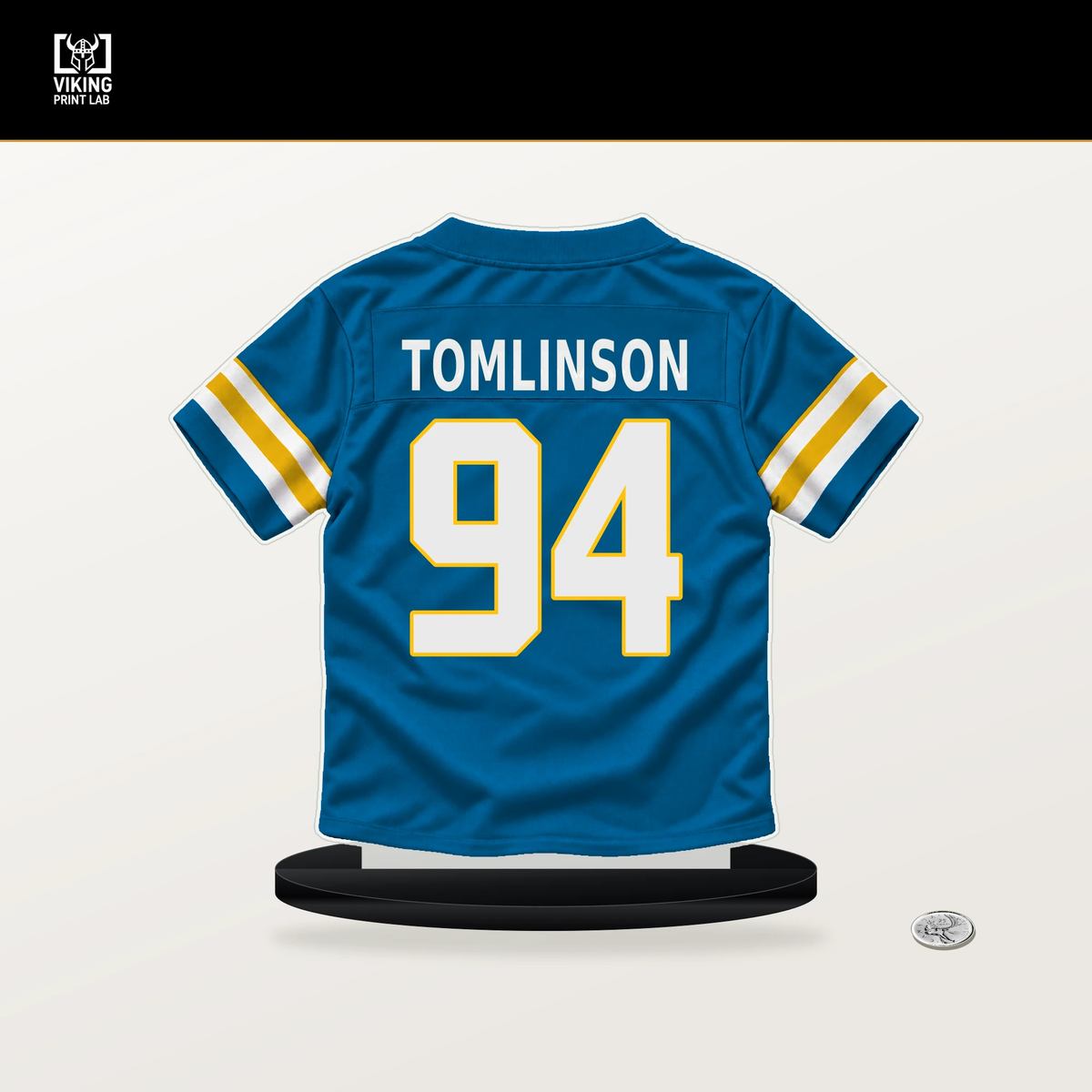 Dalvin Tomlinson number 94 Los Angeles Chargers jersey stand with included black base.