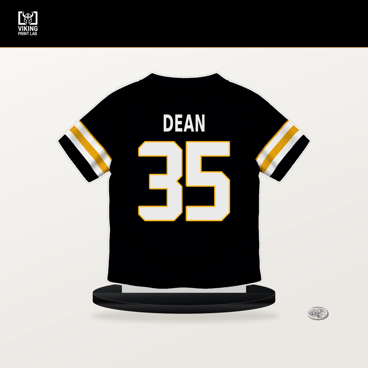 Jamel Dean number 35 Pittsburgh Steelers jersey stand with included black base.