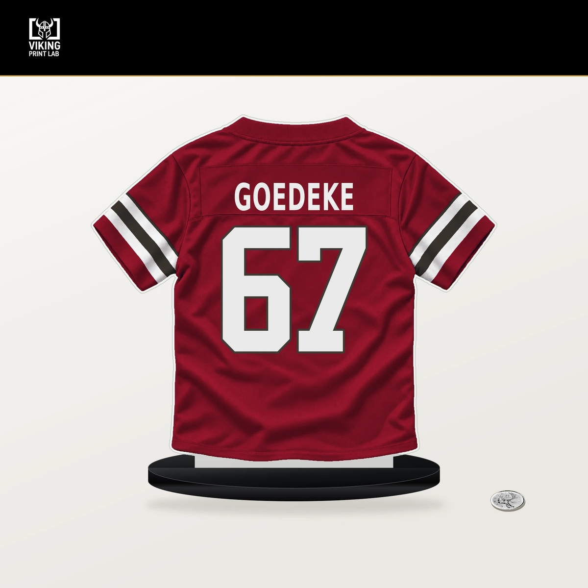 Luke Goedeke number 67 Tampa Bay Buccaneers jersey stand with included black base.