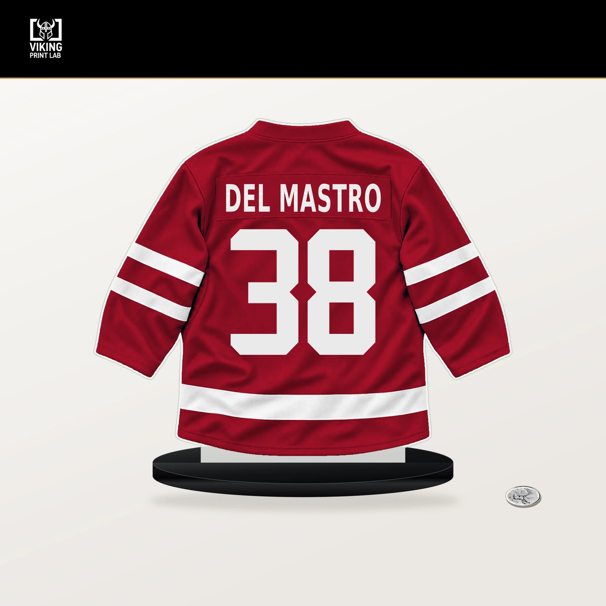 Ethan Del Mastro number 38 Chicago Blackhawks jersey stand with included black base.