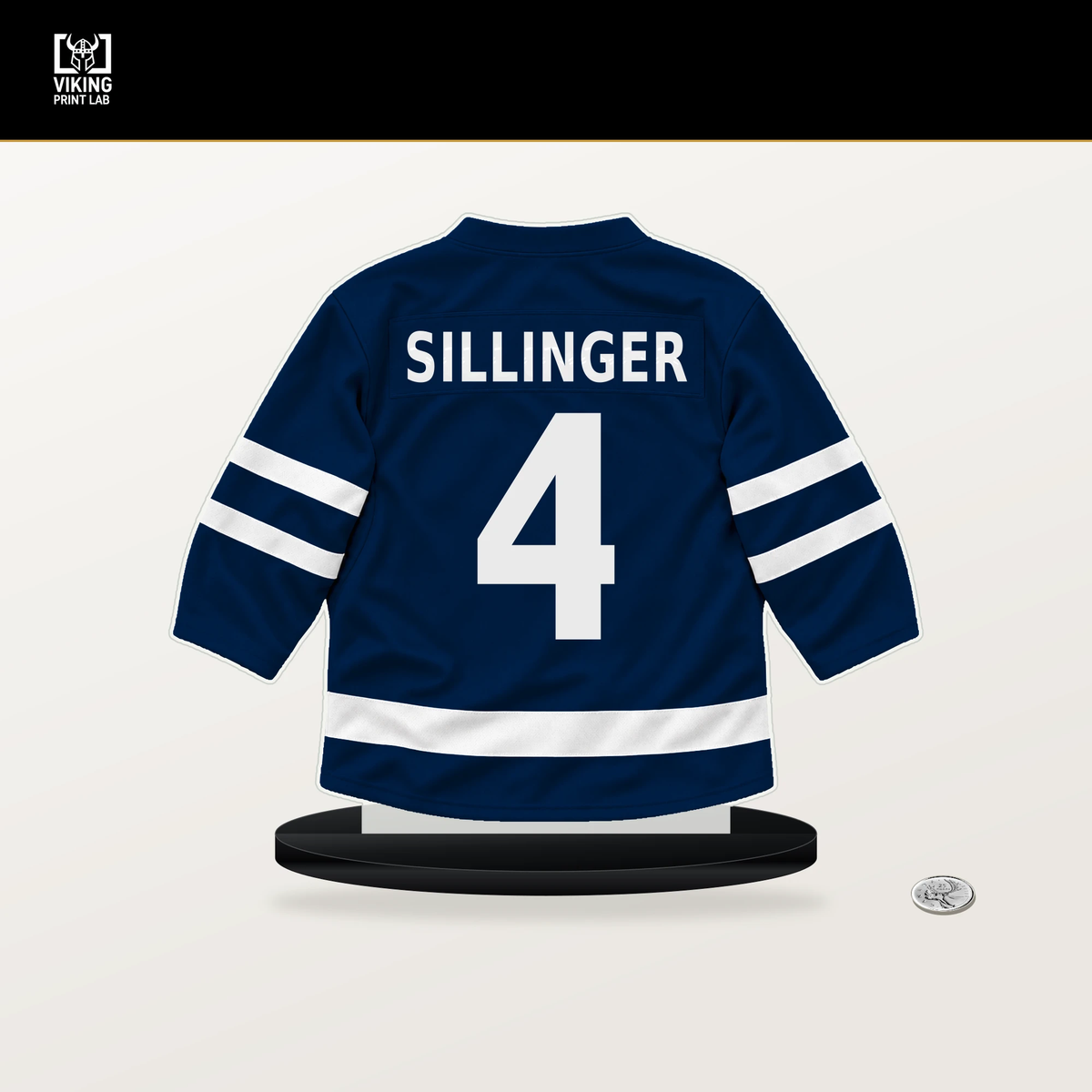 Cole Sillinger number 4 Columbus Blue Jackets jersey stand with included black base.