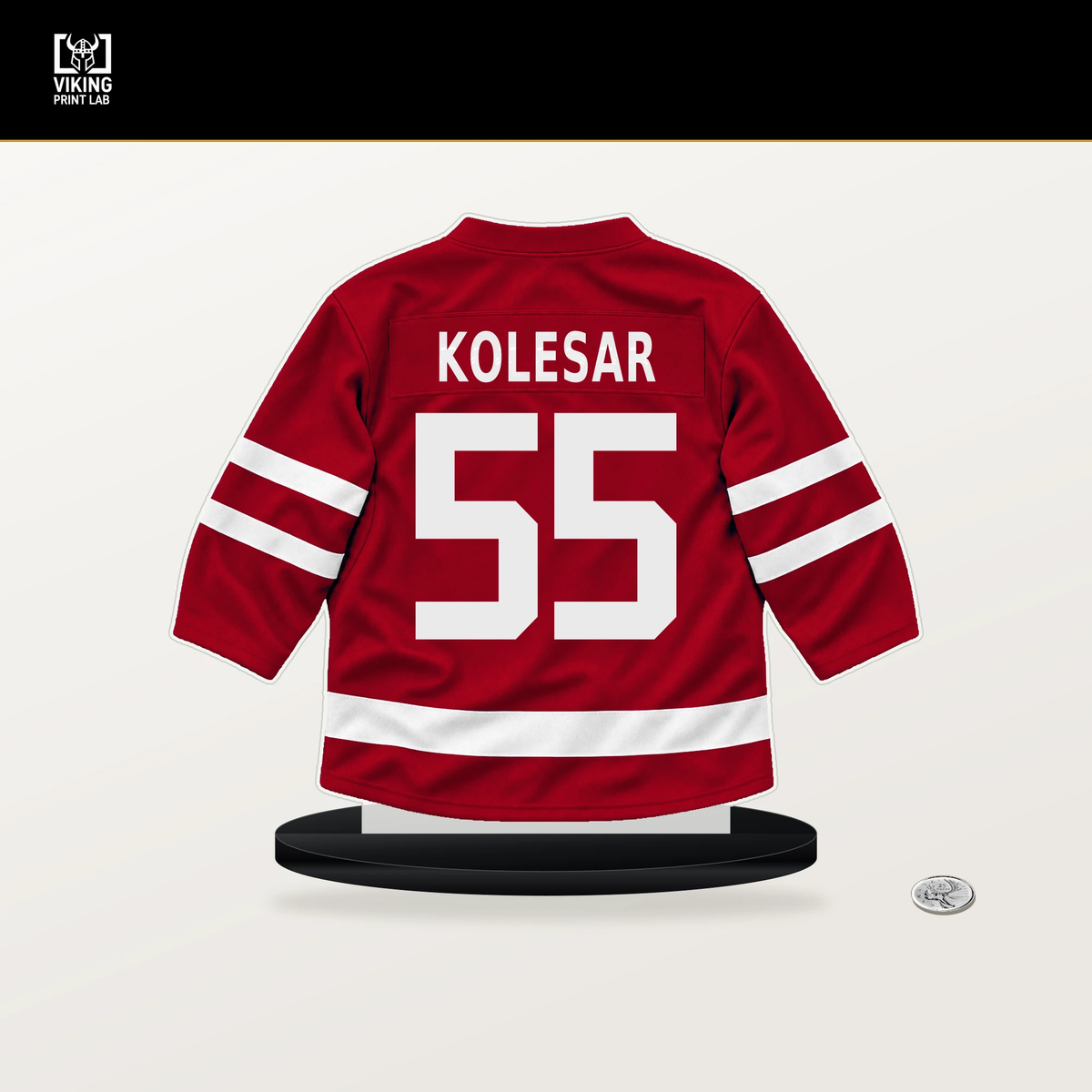 Keegan Kolesar number 55 Detroit Red Wings jersey stand with included black base.