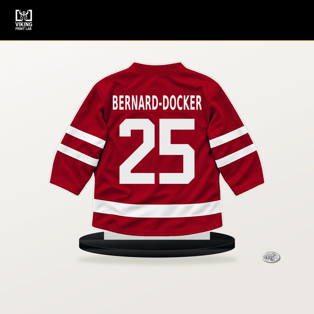 Jacob Bernard-Docker number 25 Detroit Red Wings jersey stand with included black base.
