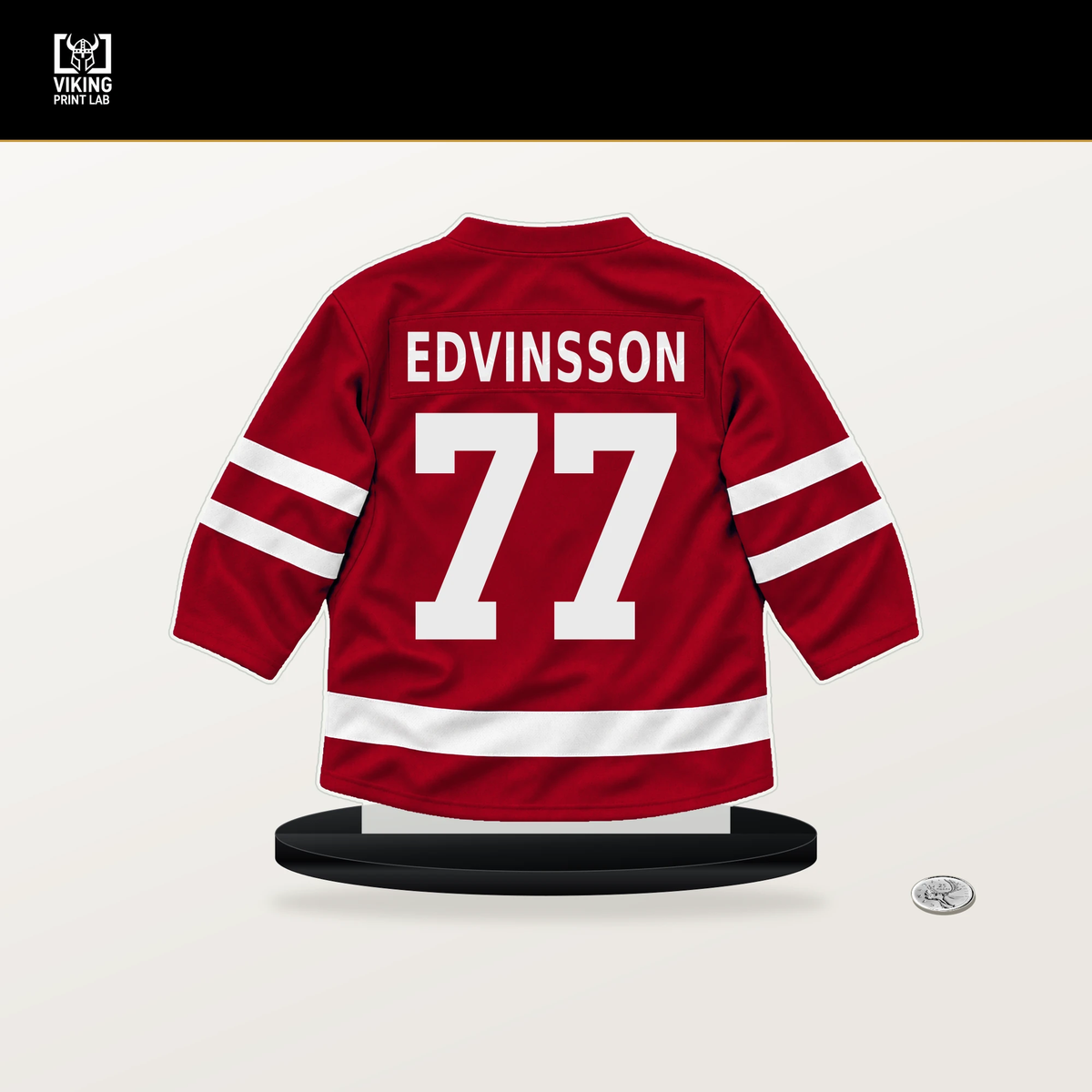 Simon Edvinsson number 77 Detroit Red Wings jersey stand with included black base.