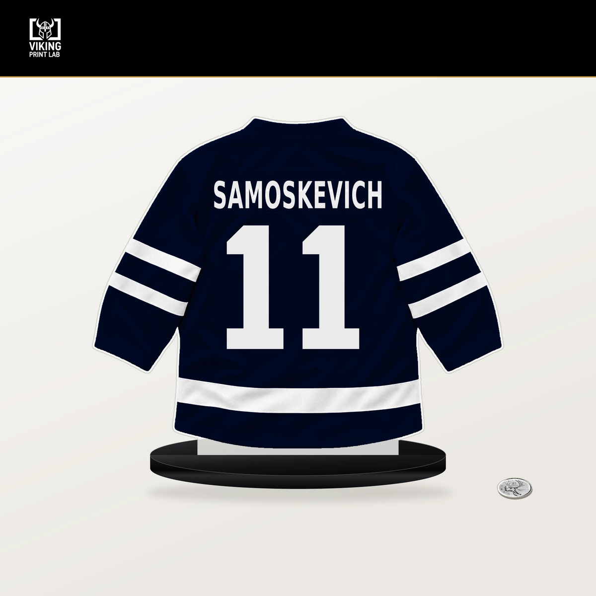 Mackie Samoskevich number 11 Seattle Kraken jersey stand with included black base.