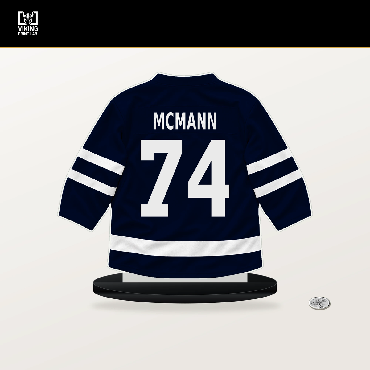 Bobby McMann number 74 Seattle Kraken jersey stand with included black base.
