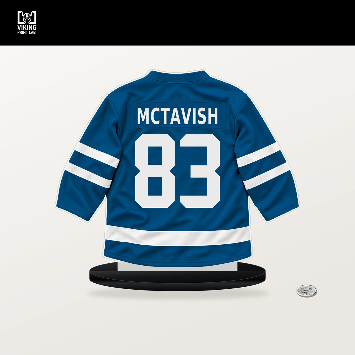 Mason McTavish number 83 St. Louis Blues jersey stand with included black base.