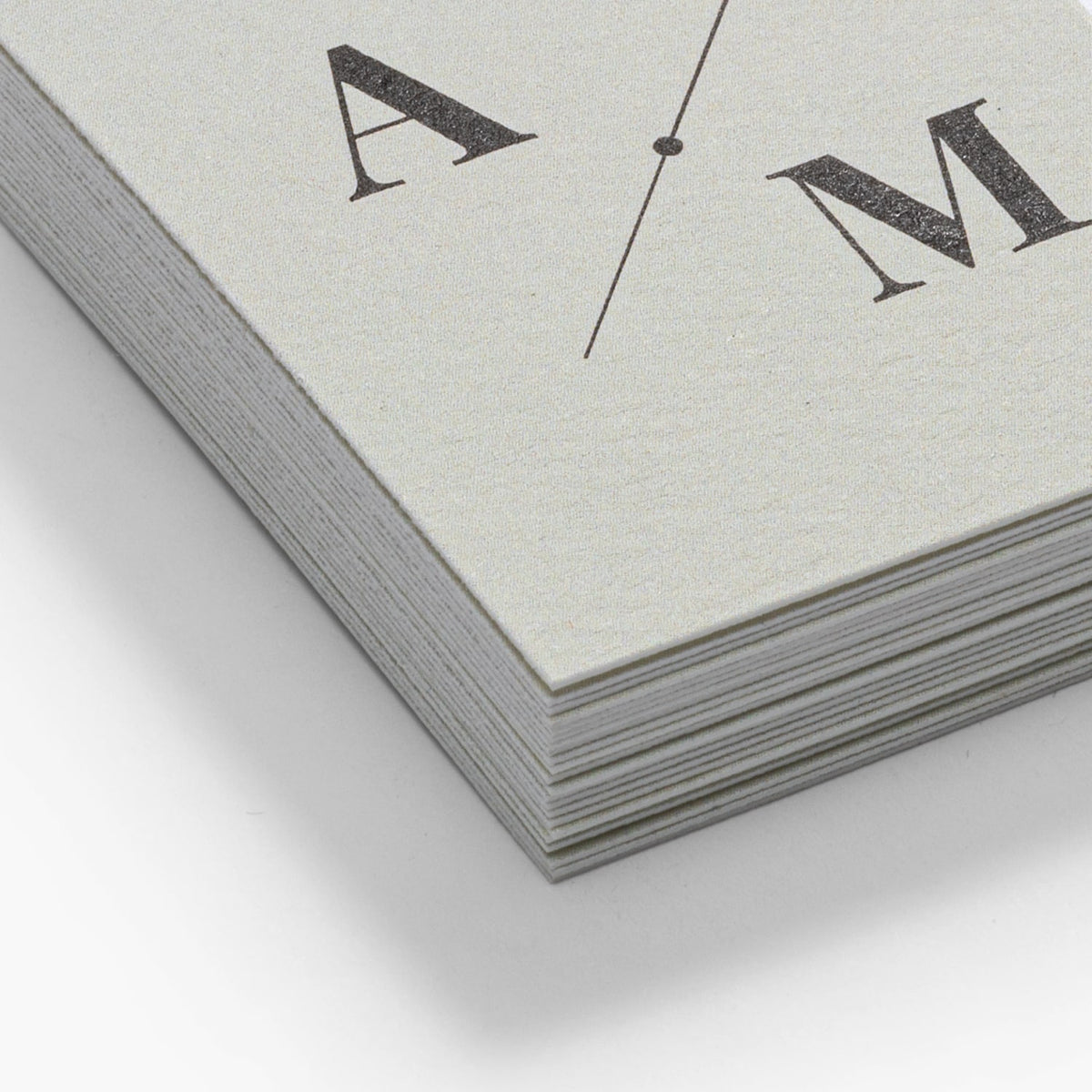 Close-up of the lightly rippled surface of natural textured business cards.