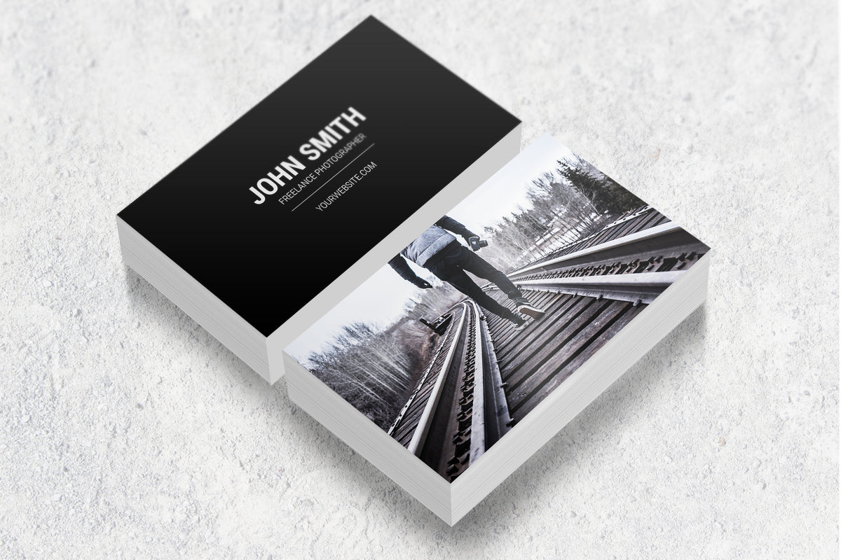 Sample laminated business cards showing a photography design on both sides.