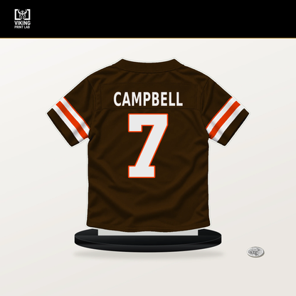Tyson Campbell number 7 Cleveland Browns jersey stand with included black base.