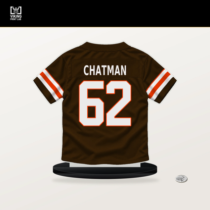 Elijah Chatman number 62 Cleveland Browns jersey stand with included black base.