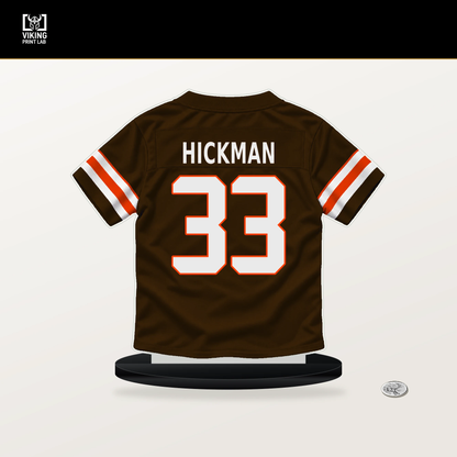 Ronnie Hickman number 33 Cleveland Browns jersey stand with included black base.