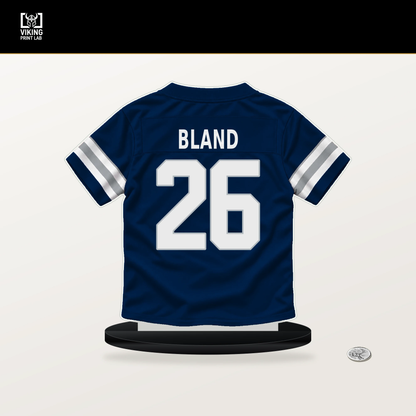 DaRon Bland number 26 Dallas Cowboys jersey stand with included black base.