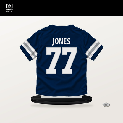 Broderick Jones number 77 Dallas Cowboys jersey stand with included black base.