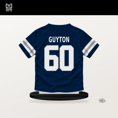 Tyler Guyton number 60 Dallas Cowboys jersey stand with included black base.