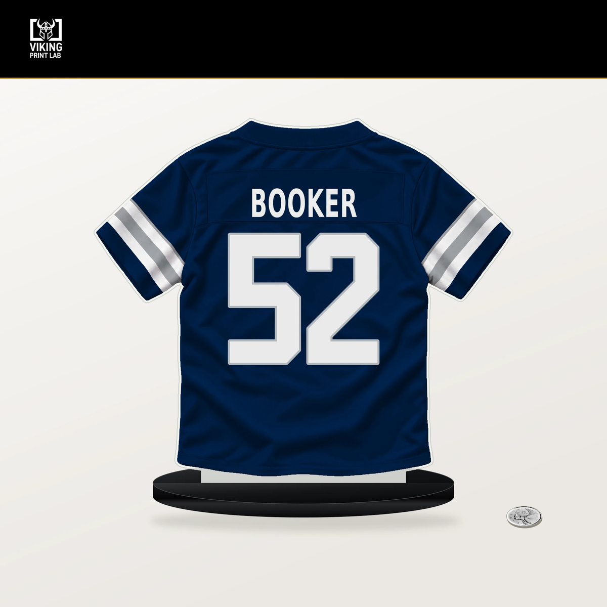 Tyler Booker number 52 Dallas Cowboys jersey stand with included black base.