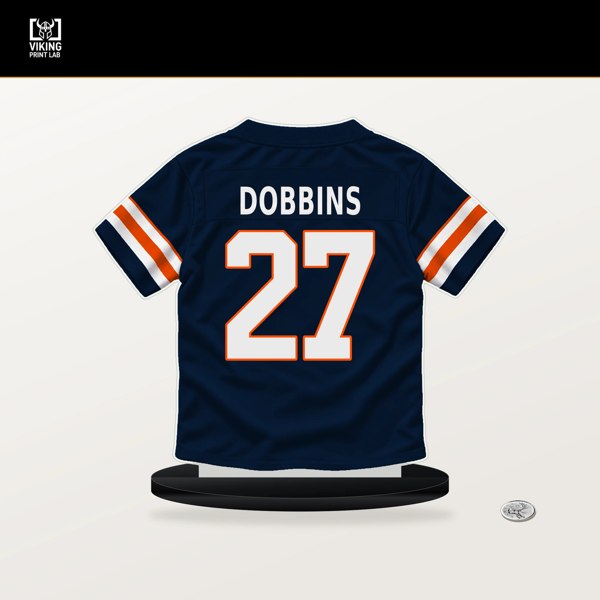 J.K. Dobbins number 27 Denver Broncos jersey stand with included black base.