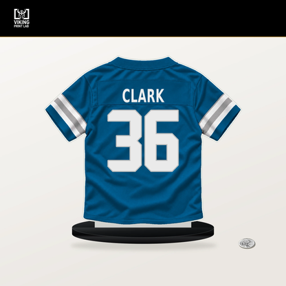 Chuck Clark number 36 Detroit Lions jersey stand with included black base.