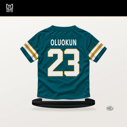 Foyesade Oluokun number 23 Jacksonville Jaguars jersey stand with included black base.