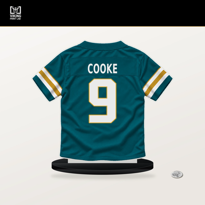 Logan Cooke number 9 Jacksonville Jaguars jersey stand with included black base.