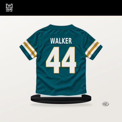 Travon Walker number 44 Jacksonville Jaguars jersey stand with included black base.