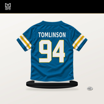 Dalvin Tomlinson number 94 Los Angeles Chargers jersey stand with included black base.