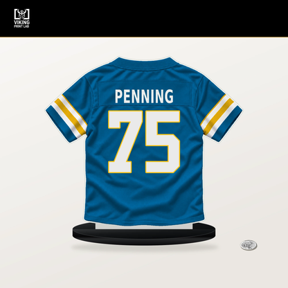 Trevor Penning number 75 Los Angeles Chargers jersey stand with included black base.