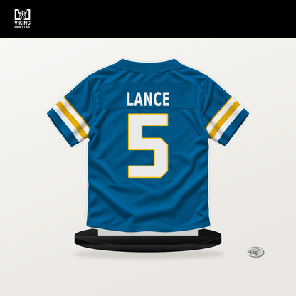 Trey Lance number 5 Los Angeles Chargers jersey stand with included black base.