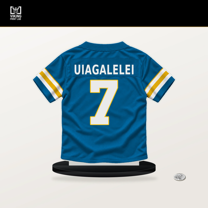DJ Uiagalelei number 7 Los Angeles Chargers jersey stand with included black base.