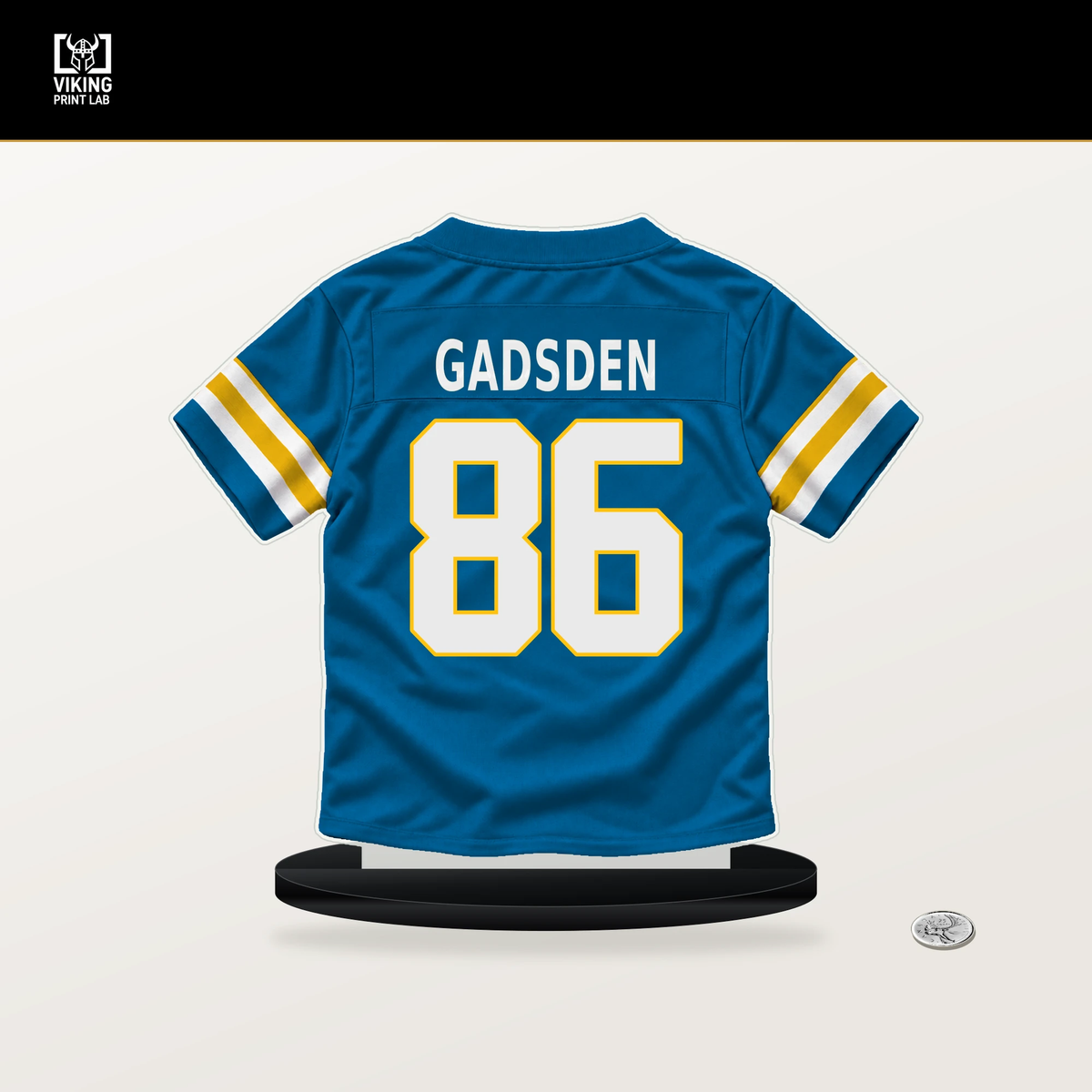 Oronde Gadsden number 86 Los Angeles Chargers jersey stand with included black base.