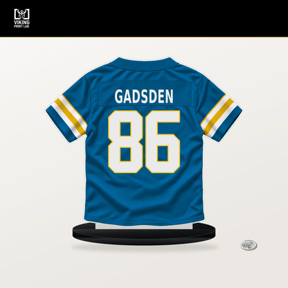 Oronde Gadsden number 86 Los Angeles Chargers jersey stand with included black base.