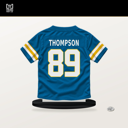 Brenen Thompson number 89 Los Angeles Chargers jersey stand with included black base.