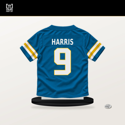 Tre' Harris number 9 Los Angeles Chargers jersey stand with included black base.
