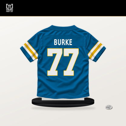 Travis Burke number 77 Los Angeles Chargers jersey stand with included black base.