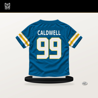 Jamaree Caldwell number 99 Los Angeles Chargers jersey stand with included black base.