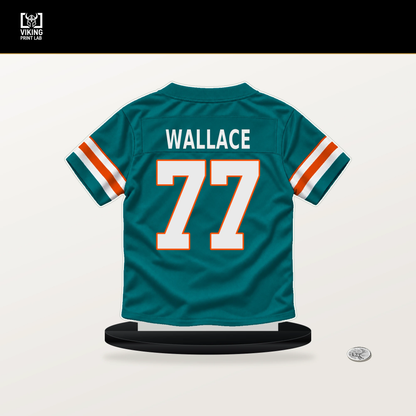 Caedan Wallace number 77 Miami Dolphins jersey stand with included black base.
