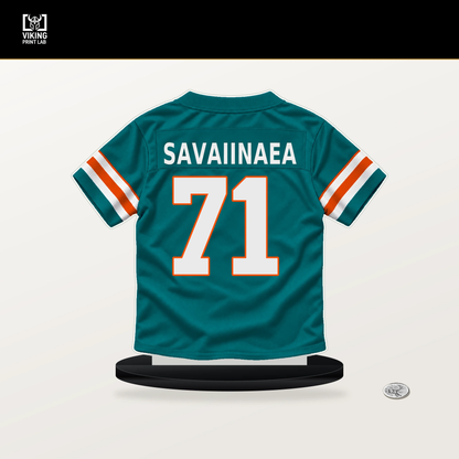 Jonah Savaiinaea number 71 Miami Dolphins jersey stand with included black base.