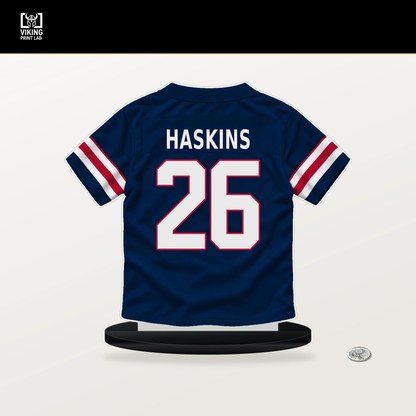 Hassan Haskins number 26 New England Patriots jersey stand with included black base.