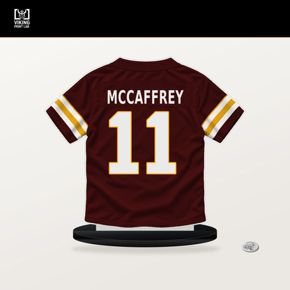 Luke McCaffrey number 11 Washington Commanders jersey stand with included black base.