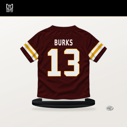 Treylon Burks number 13 Washington Commanders jersey stand with included black base.