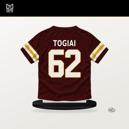 Tanoa Togiai number 62 Washington Commanders jersey stand with included black base.