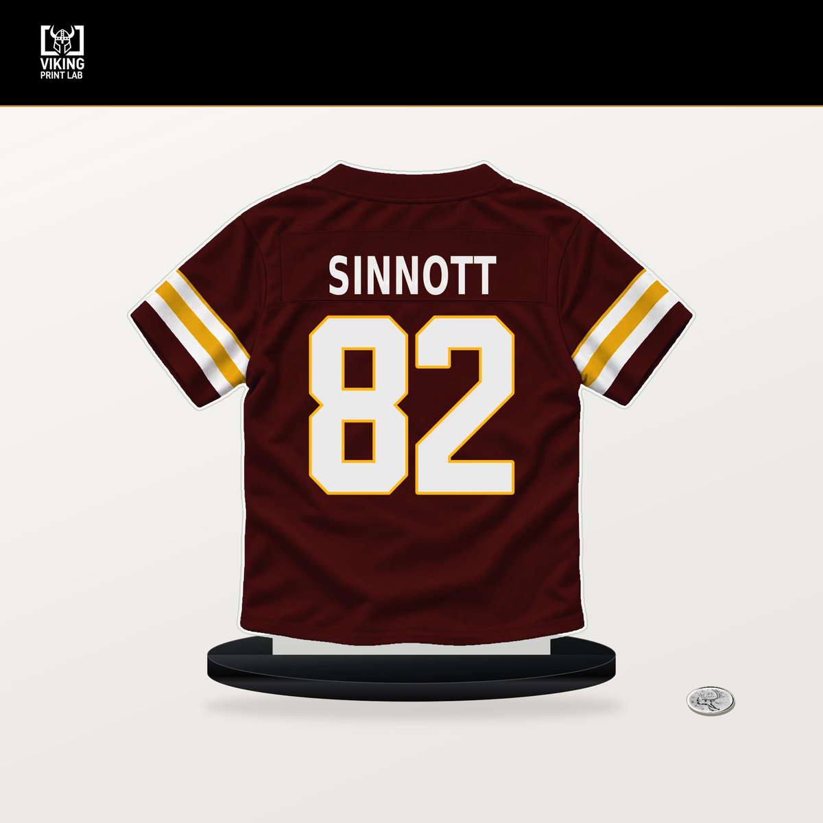 Ben Sinnott number 82 Washington Commanders jersey stand with included black base.