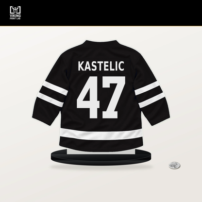 Mark Kastelic number 47 Boston Bruins jersey stand with included black base.
