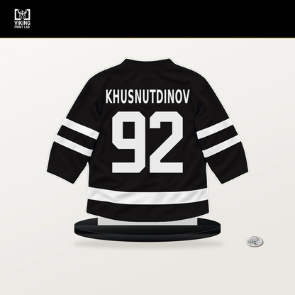 Marat Khusnutdinov number 92 Boston Bruins jersey stand with included black base.