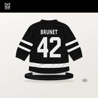 Frederic Brunet number 42 Boston Bruins jersey stand with included black base.