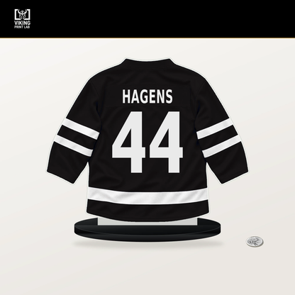 James Hagens number 44 Boston Bruins jersey stand with included black base.