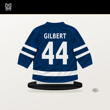 Dennis Gilbert number 44 Buffalo Sabres jersey stand with included black base.